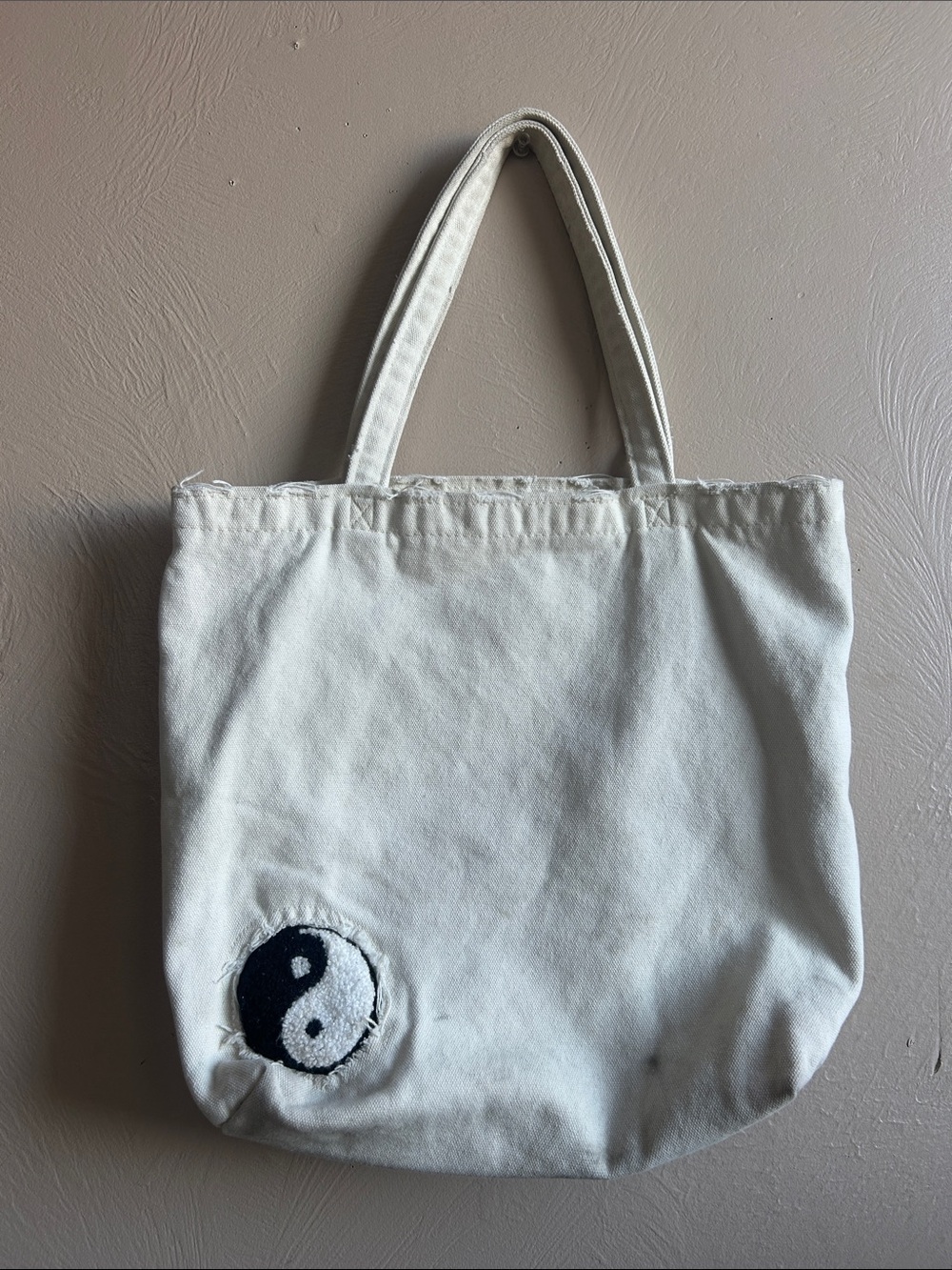 Urban Outfitters Distressed Canvas Yin Yang Patch Tote Bag. Off White Color.